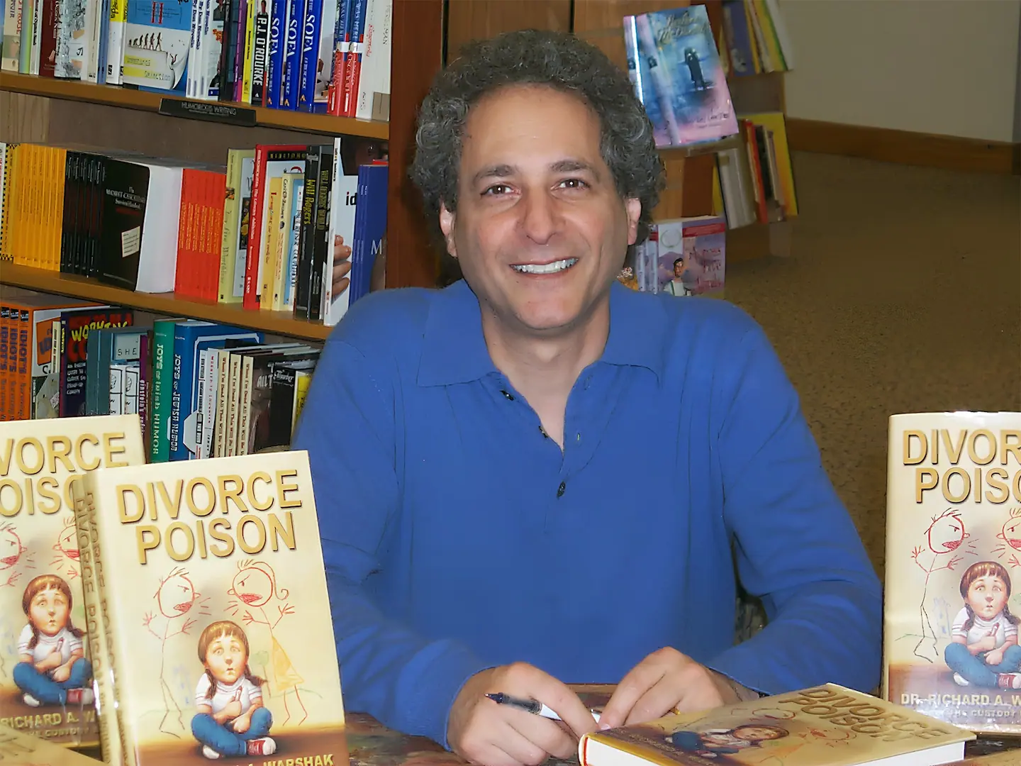 Learn about Dr Richard Warshak pictured at his Divorce Poison book signing.