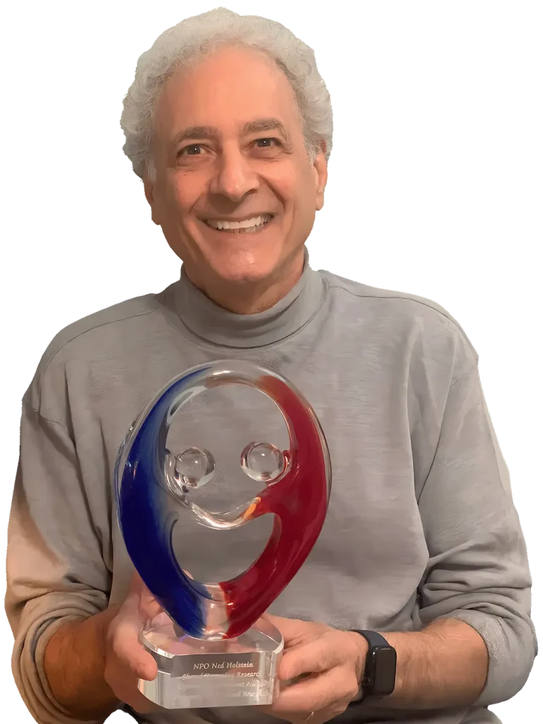 Dr Richard Warshak holding his Ned Holstein Shared Parenting Research Lifetime Achievement Award from the National Parents Organization