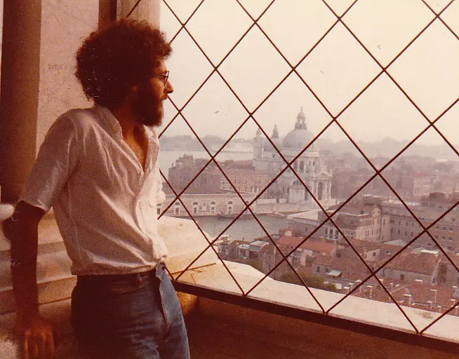 Rick looking out a window across the city in Venice 1979